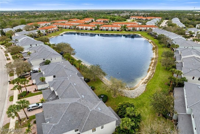 drone / aerial view featuring a water view and a residential view