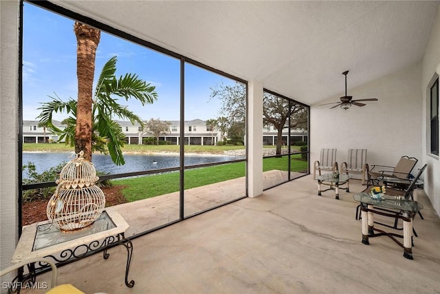 sunroom with a water view, ceiling fan, and vaulted ceiling