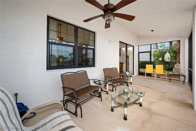 sunroom featuring lofted ceiling and ceiling fan