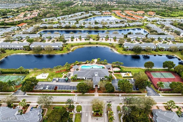 drone / aerial view with a water view and a residential view