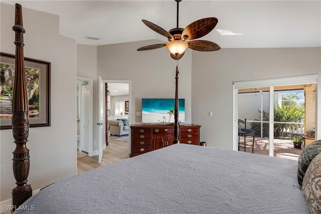 bedroom with ceiling fan, wood finished floors, visible vents, access to exterior, and vaulted ceiling