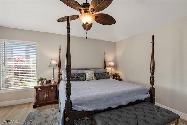 bedroom featuring ceiling fan, wood finished floors, and baseboards