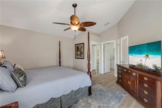 bedroom with visible vents, a ceiling fan, ensuite bath, light wood-style flooring, and vaulted ceiling