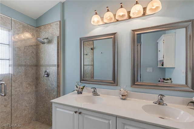 bathroom featuring double vanity, a sink, and a shower stall