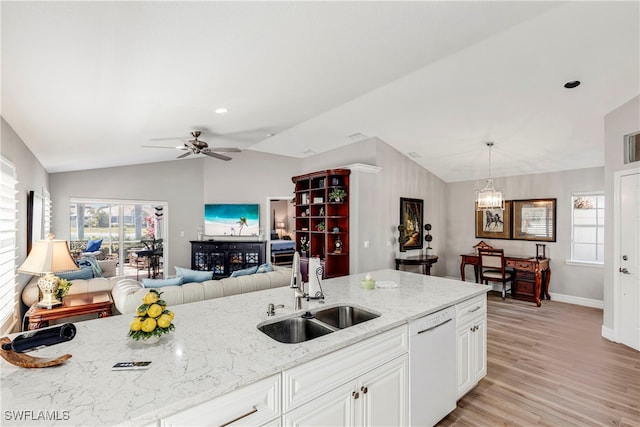 kitchen featuring vaulted ceiling, dishwasher, open floor plan, and a sink