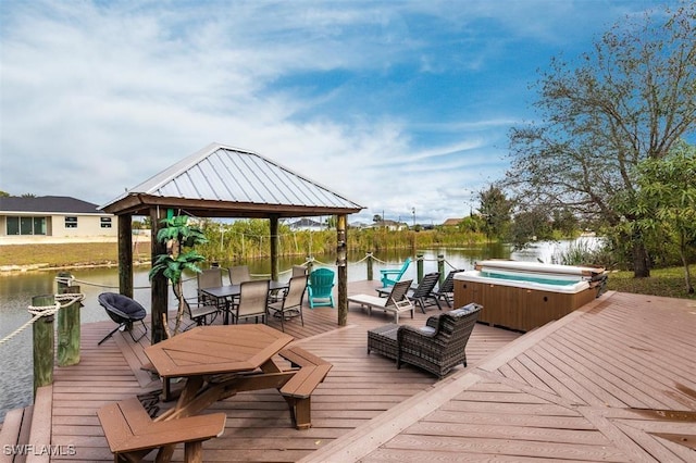 view of dock featuring a deck with water view, a hot tub, and a gazebo