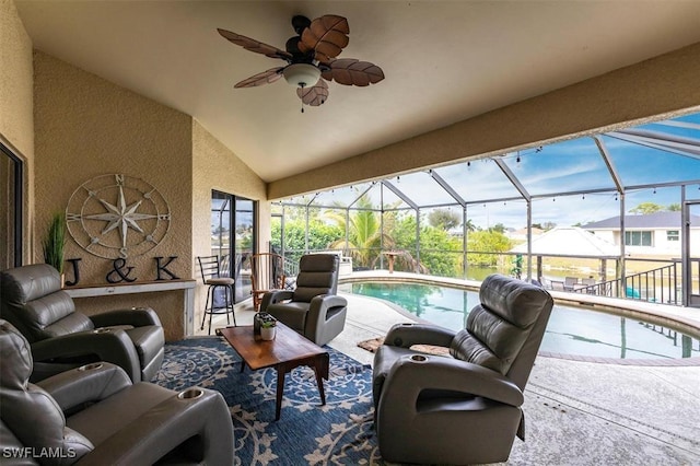 sunroom / solarium with lofted ceiling and a ceiling fan