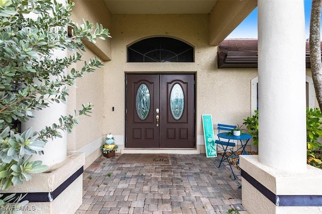 doorway to property with stucco siding