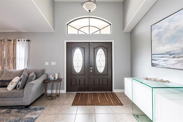 entryway with baseboards and tile patterned floors