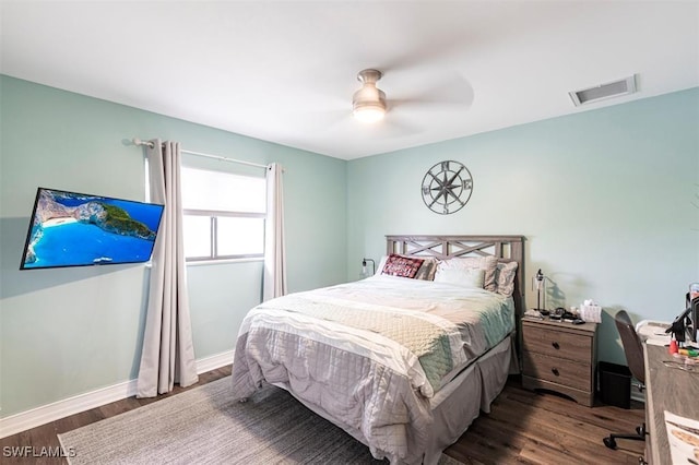 bedroom with baseboards, visible vents, ceiling fan, and wood finished floors