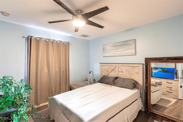 bedroom featuring a ceiling fan, dark wood-style flooring, and visible vents