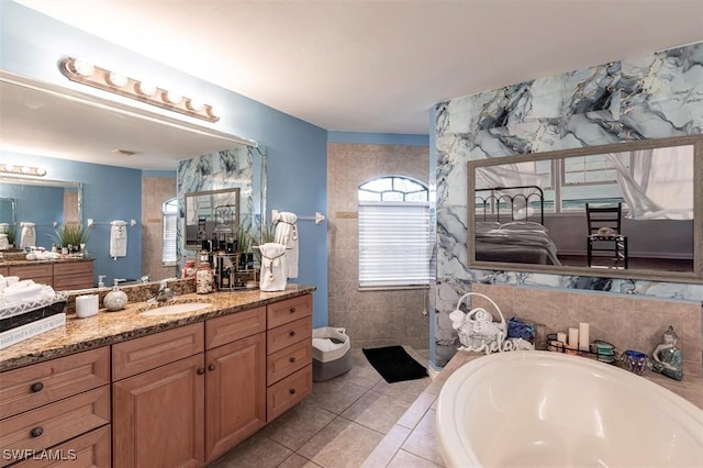 bathroom with a walk in shower, tile patterned flooring, a garden tub, and vanity