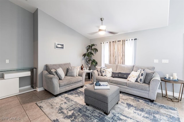 tiled living area featuring vaulted ceiling, ceiling fan, and baseboards