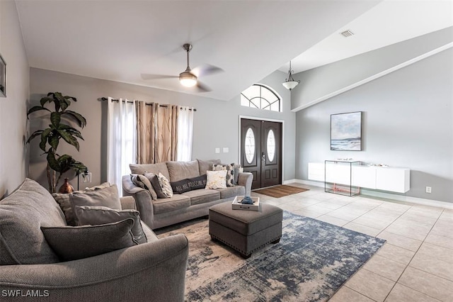 tiled living area featuring high vaulted ceiling, visible vents, ceiling fan, and baseboards