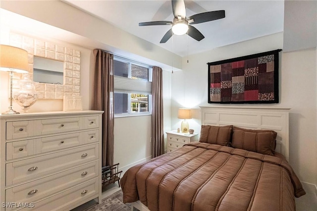 bedroom with baseboards and a ceiling fan