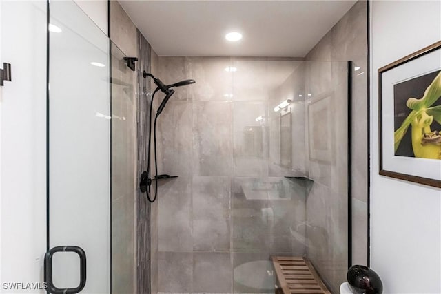 bathroom featuring a shower stall and toilet