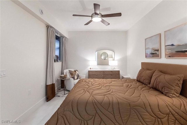 bedroom with ceiling fan, baseboards, and light colored carpet