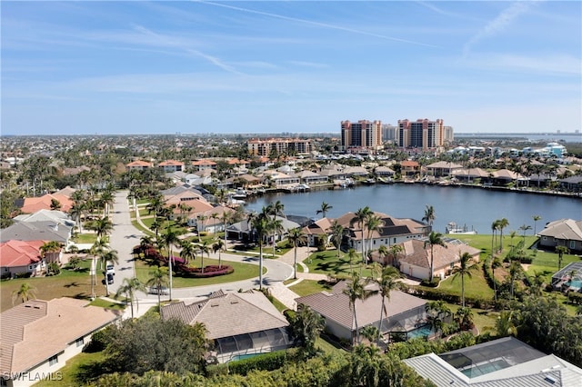 drone / aerial view featuring a water view and a residential view