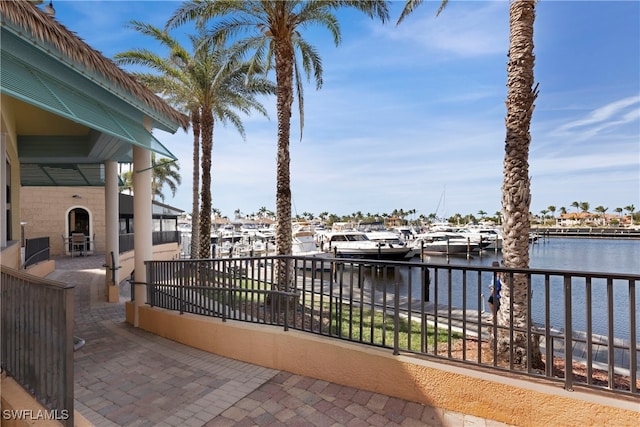 view of patio / terrace with a water view and a boat dock