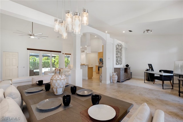 dining area featuring arched walkways, high vaulted ceiling, ceiling fan, baseboards, and ornate columns