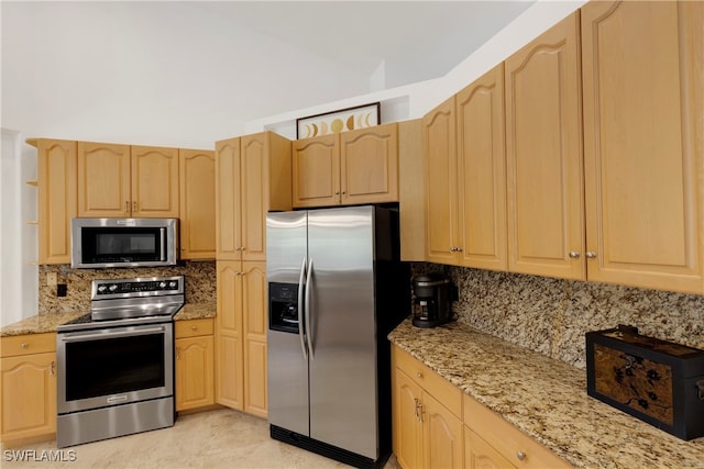 kitchen featuring stainless steel appliances, backsplash, and light brown cabinetry