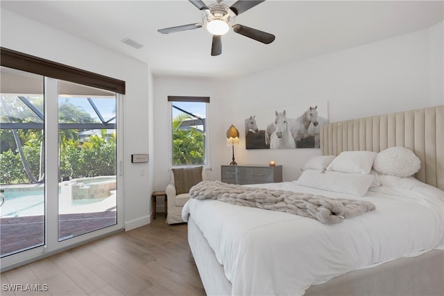 bedroom featuring wood finished floors, a ceiling fan, baseboards, visible vents, and access to exterior