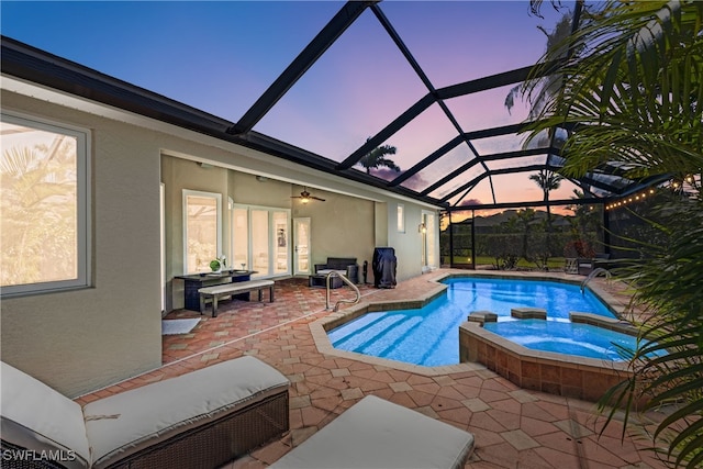 view of swimming pool featuring a patio, a lanai, and a pool with connected hot tub