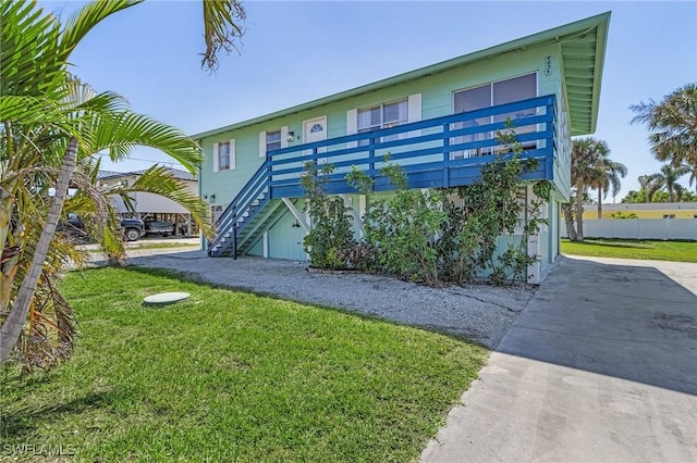 7431 Barrancas Ave, Bokeelia, FL 33922 - exterior space featuring a front yard, driveway, and stairs