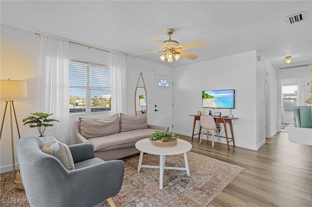 7431 Barrancas Ave, Bokeelia, FL 33922 - living area with visible vents, ceiling fan, baseboards, and wood finished floors