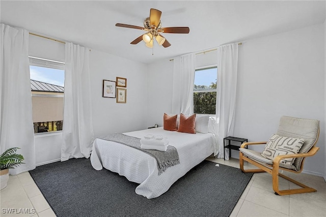7431 Barrancas Ave, Bokeelia, FL 33922 - bedroom featuring light tile patterned floors, baseboards, and a ceiling fan