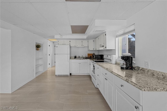7431 Barrancas Ave, Bokeelia, FL 33922 - kitchen featuring white appliances, white cabinets, a sink, and a drop ceiling