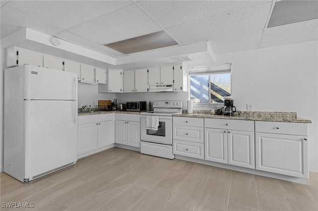 7431 Barrancas Ave, Bokeelia, FL 33922 - kitchen with white appliances, white cabinets, and under cabinet range hood