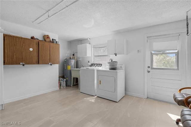 7431 Barrancas Ave, Bokeelia, FL 33922 - clothes washing area featuring electric water heater, independent washer and dryer, a textured ceiling, and baseboards