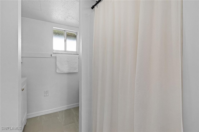 7431 Barrancas Ave, Bokeelia, FL 33922 - bathroom with baseboards and a textured ceiling