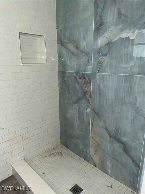 full bathroom with a tile shower