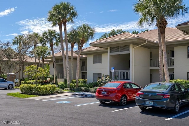 view of property featuring uncovered parking