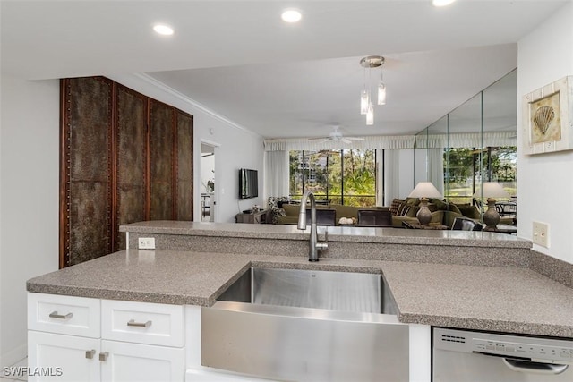 kitchen with recessed lighting, stainless steel dishwasher, a ceiling fan, open floor plan, and a sink