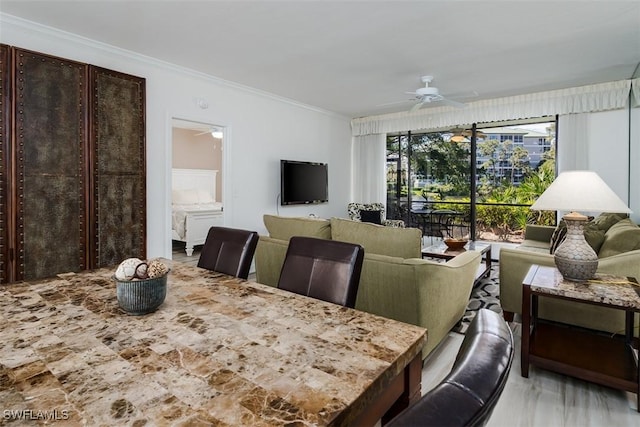 dining room with ornamental molding and ceiling fan