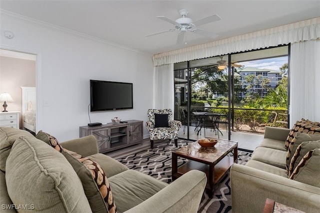 living room with ceiling fan and ornamental molding