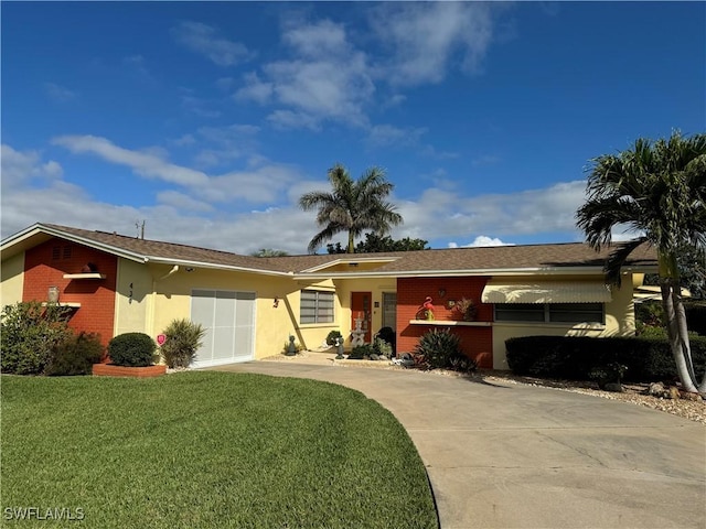 ranch-style home with a garage, driveway, stucco siding, a front lawn, and brick siding