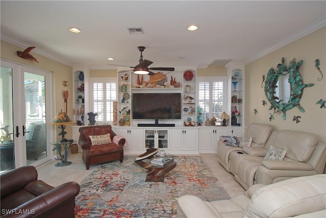 living room featuring a healthy amount of sunlight, visible vents, crown molding, and ceiling fan