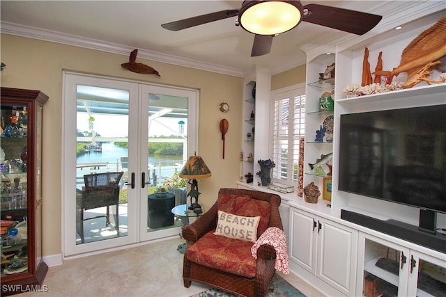 sitting room featuring a ceiling fan, french doors, and crown molding