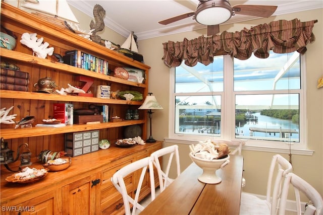 dining space with ornamental molding and a ceiling fan