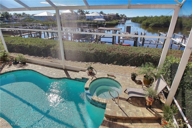 view of swimming pool featuring a water view, boat lift, a pool with connected hot tub, and a boat dock