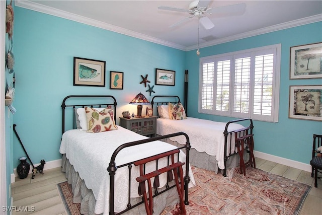 bedroom featuring baseboards, ornamental molding, and wood finished floors