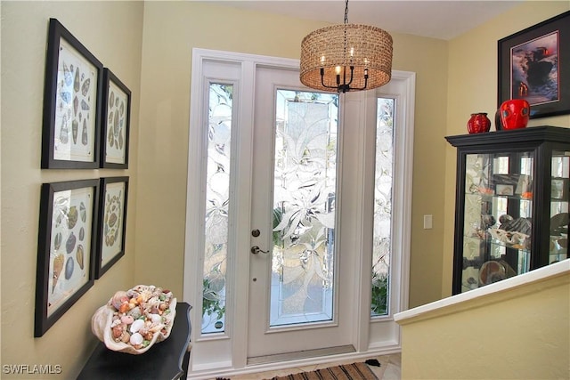 entryway featuring a chandelier