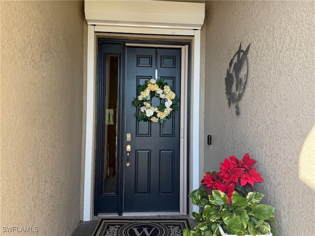 entrance to property with stucco siding