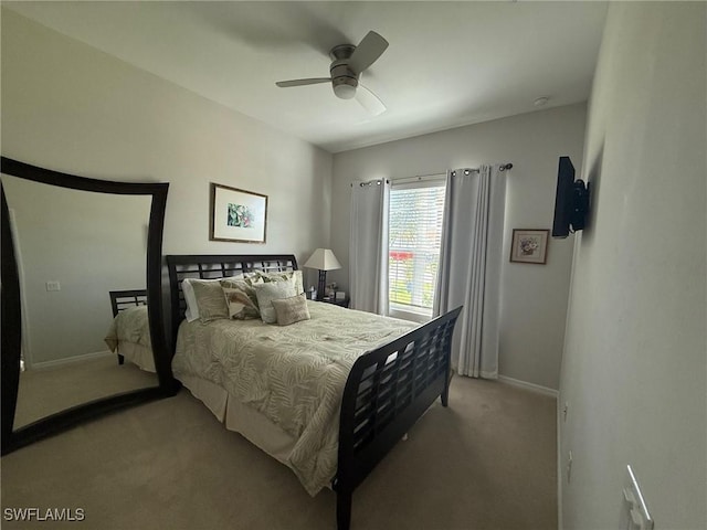 bedroom featuring baseboards, carpet floors, and a ceiling fan