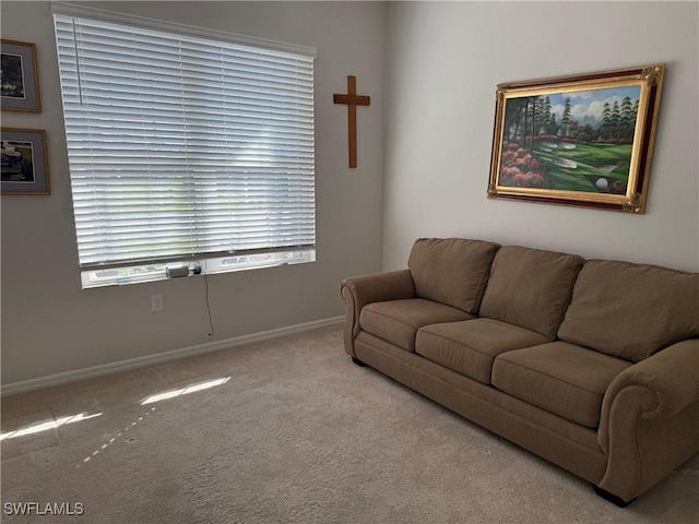 carpeted living area with baseboards