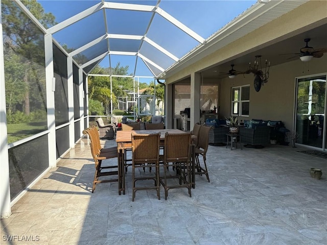 sunroom / solarium featuring lofted ceiling and ceiling fan